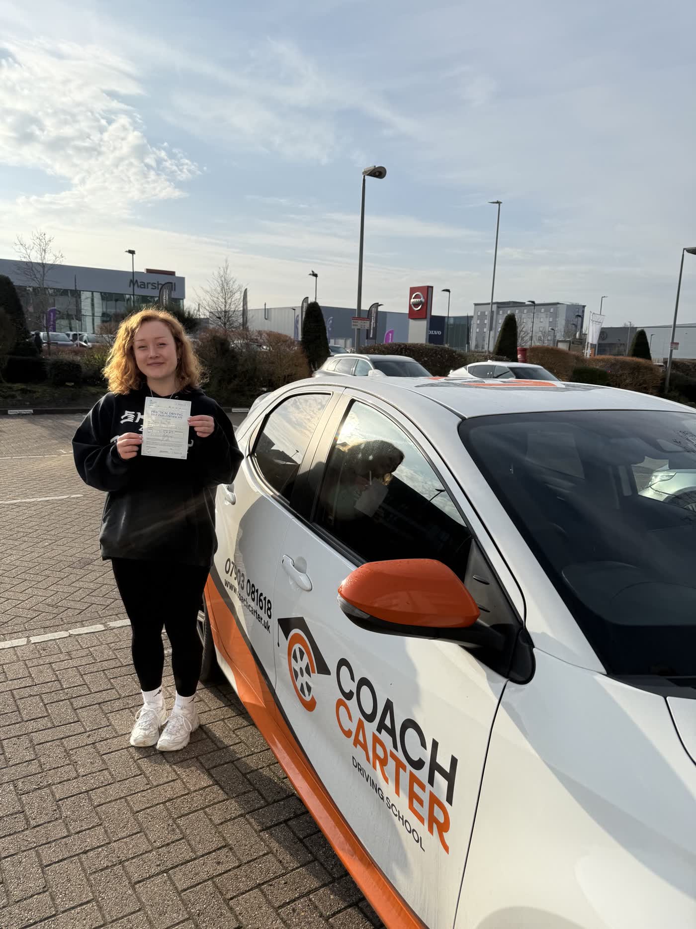CoachCarter learner holding their driving test pass certificate