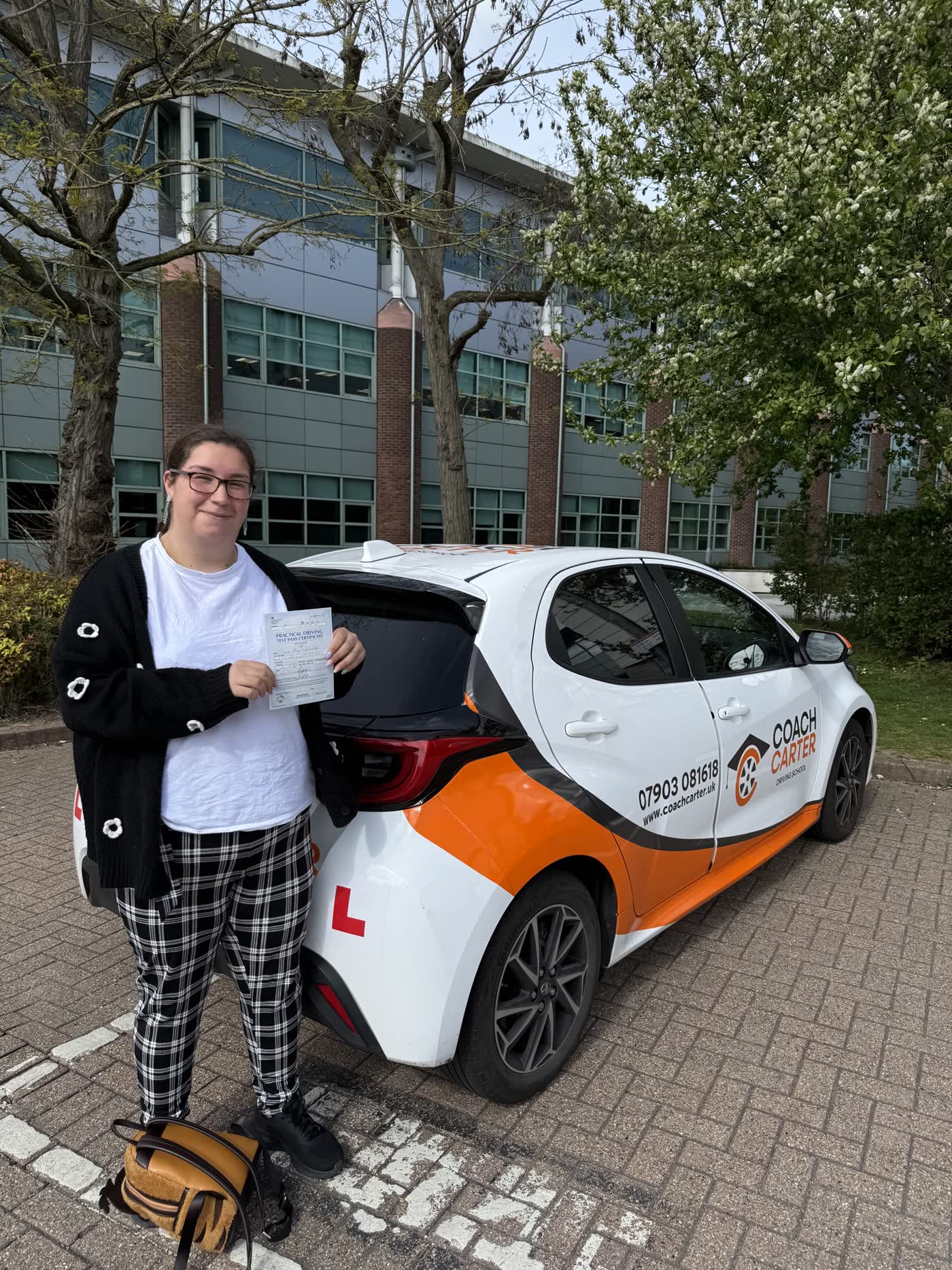CoachCarter learner holding their driving test pass certificate